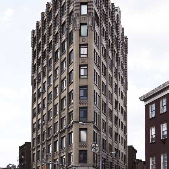 a very tall building sitting on the side of a road