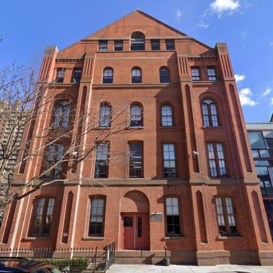 an old brick building with many windows on it