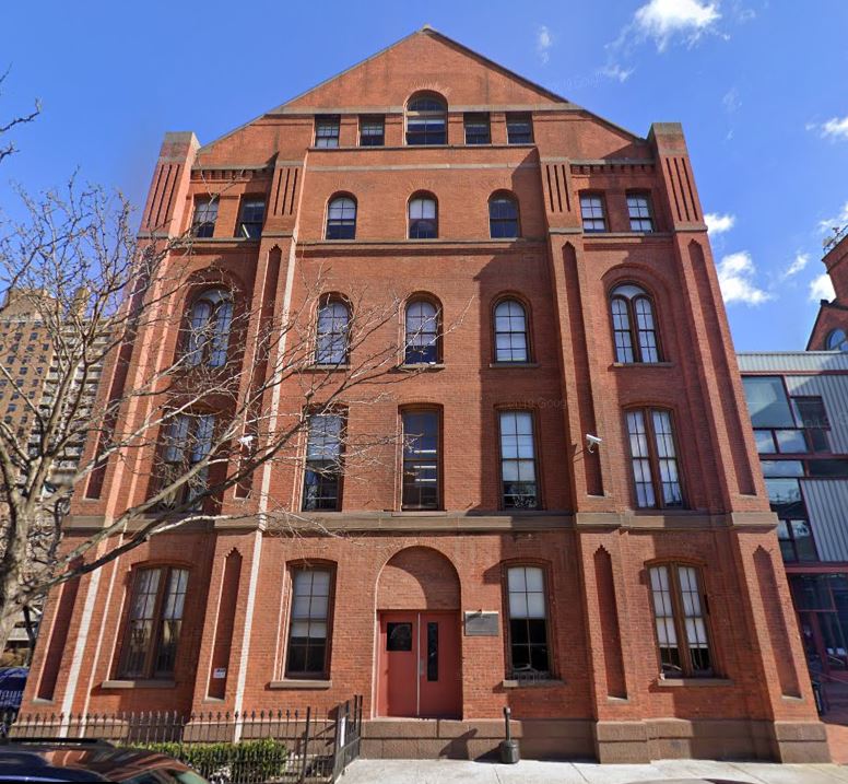 an old brick building with many windows on it