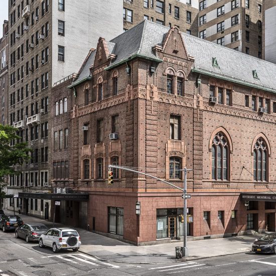 an old brick building in the middle of a city