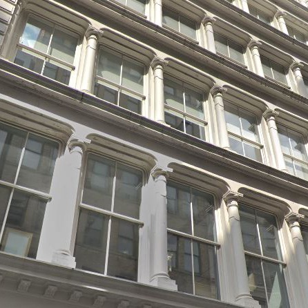 a tall building with many windows and white trim