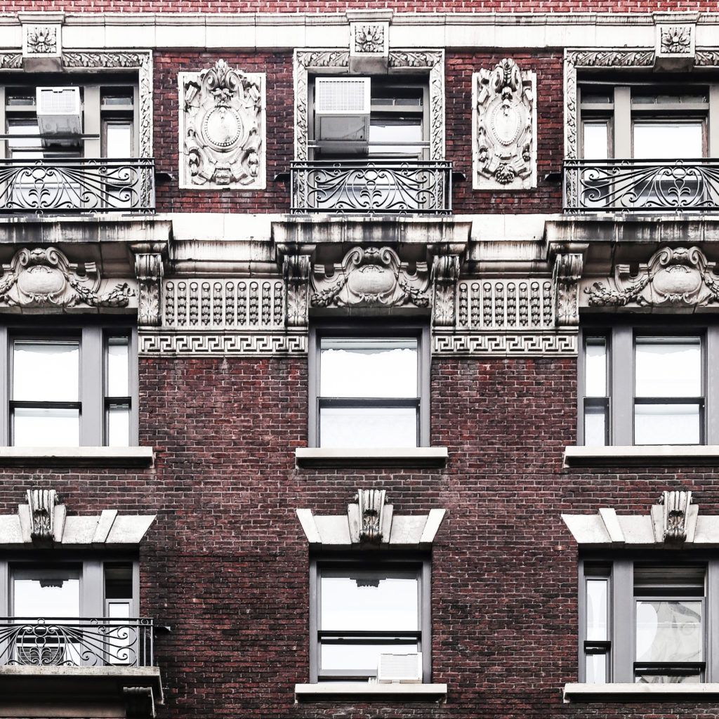 an apartment building with many windows and balconies