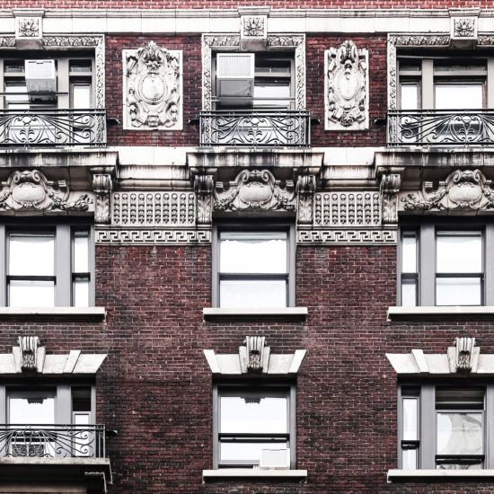 an apartment building with many windows and balconies