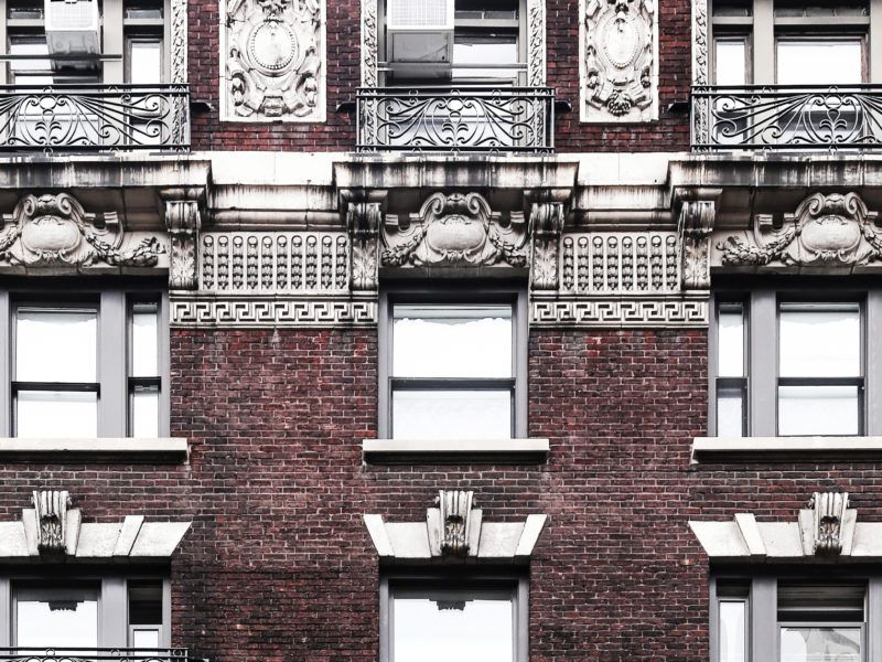 an apartment building with many windows and balconies