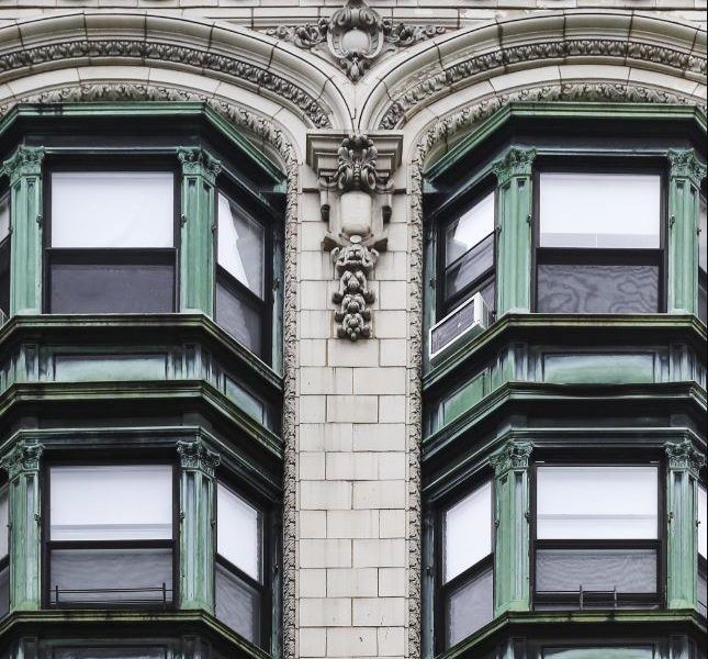 the corner of an old building with windows