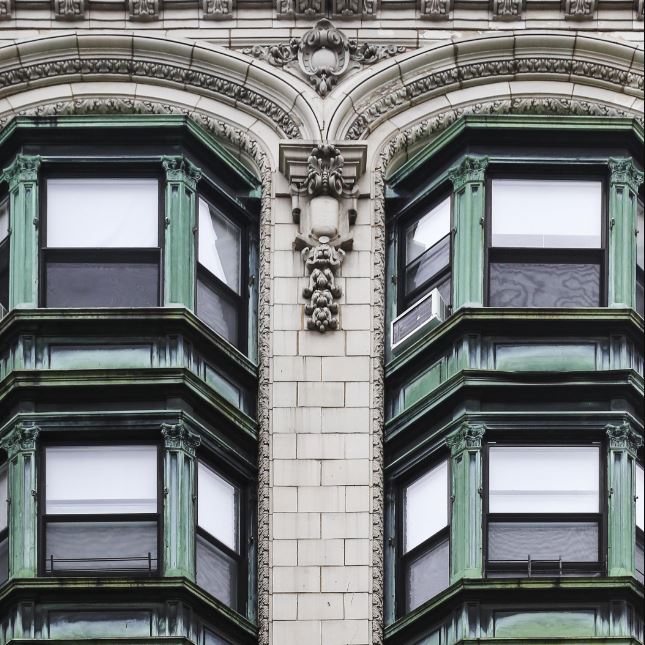 the corner of an old building with windows