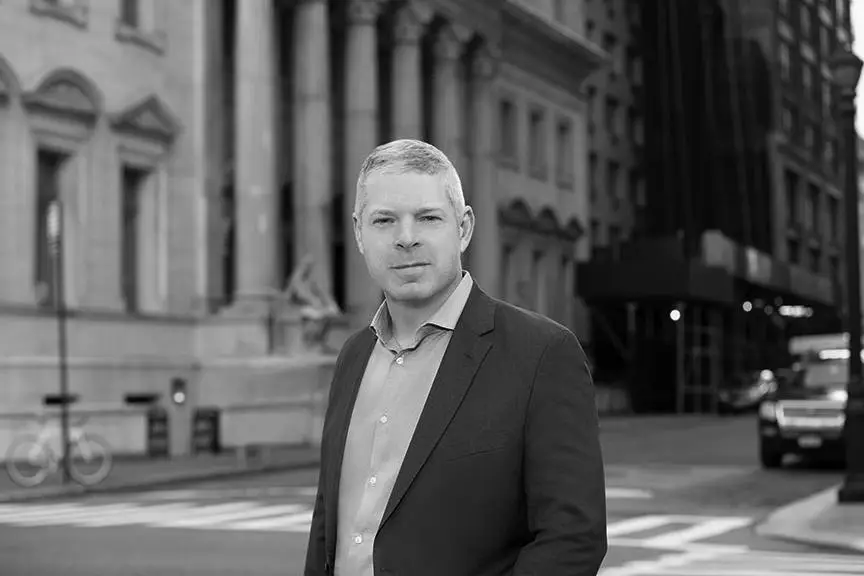 a man in a suit standing on the street