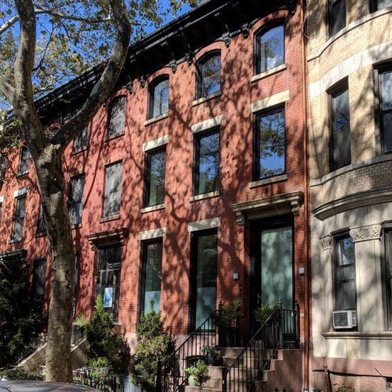 a row of brownstone townhouses in the city
