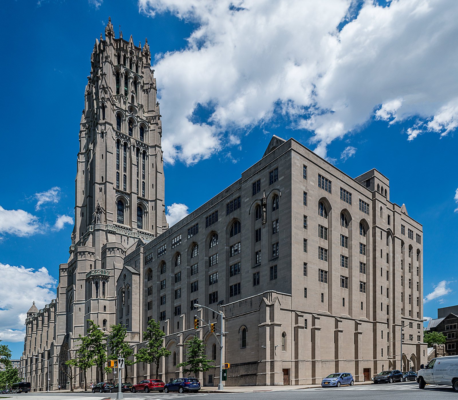 a large building with a tall tower next to a street