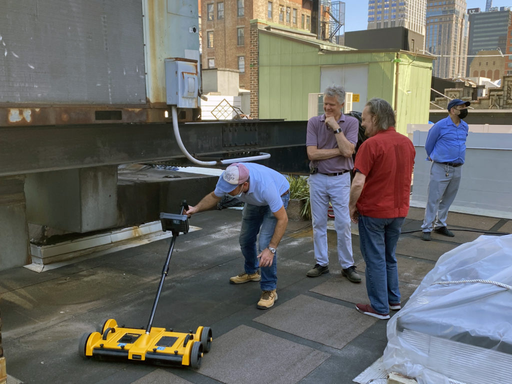 a group of people standing on top of a roof