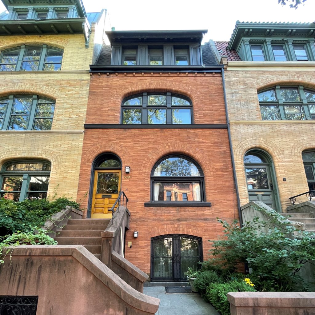 a brick building with many windows and stairs