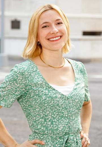 a woman standing in the street with her hands on her hips