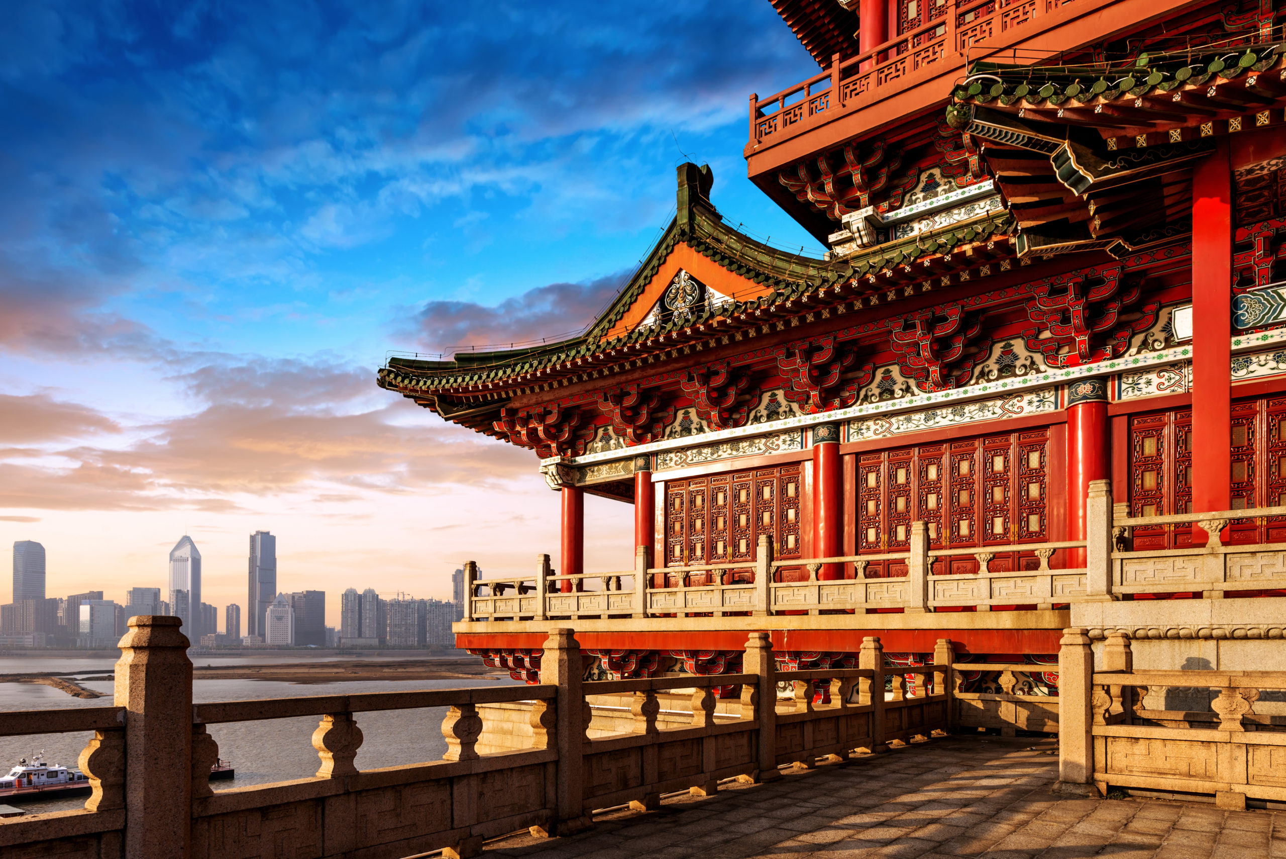 a red building with an oriental roof on the side