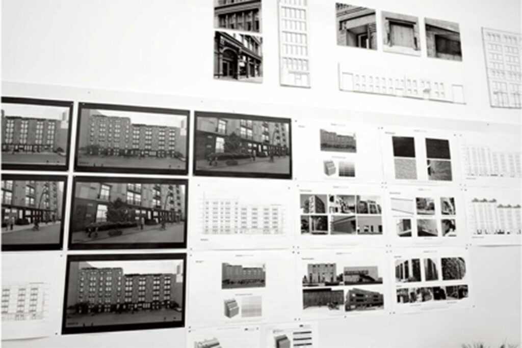 black and white photograph of architectural drawings on wall