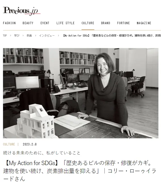 a woman is standing in front of a desk