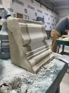 a man working on a sculpture in a shop