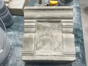 a stone fountain sitting on top of a table