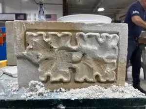 a man working on a sculpture in a shop