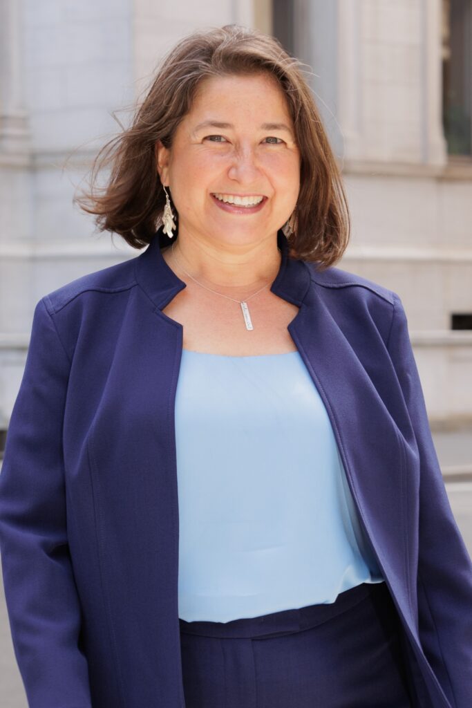 a woman wearing a blue jacket and pants