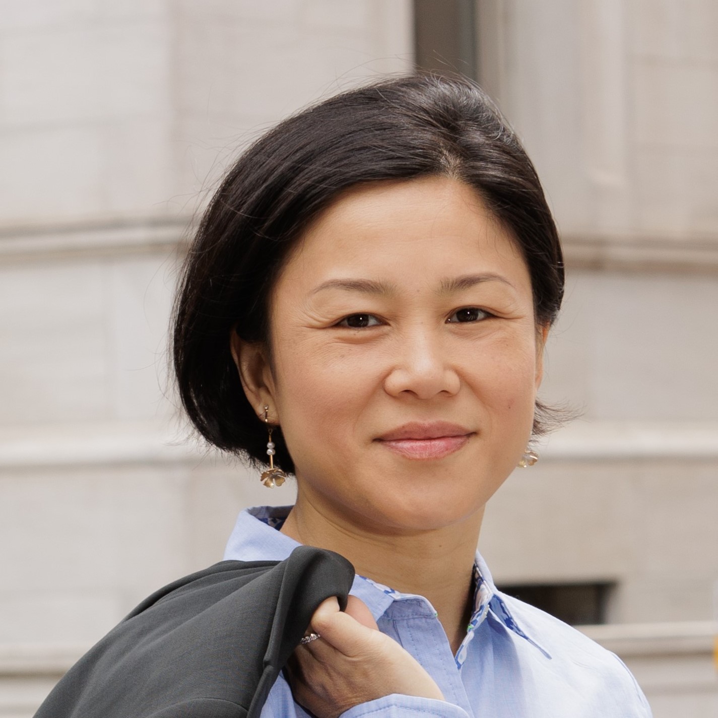 a woman with a blue shirt and black backpack