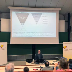 Dispatch From Innsbruck: International Passive House Conference 3 a man standing at a podium in front of a group of people