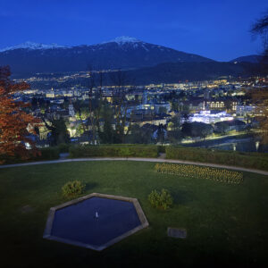a view of a city at night from a hill